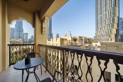 a table on a balcony with a view of the city at Classy Design 2BR in Old Town w/ Burj Khalifa View in Dubai