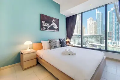 a bedroom with a large bed and a large window at Vacationer I Elegant 1 Bedroom Apartment I Marina Views I Walk to Marina Mall I Silverene Tower B in Dubai