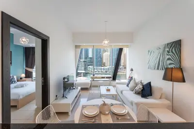 a living room with a couch and a table at Vacationer I Elegant 1 Bedroom Apartment I Marina Views I Walk to Marina Mall I Silverene Tower B in Dubai