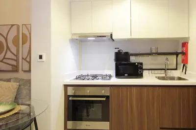 a kitchen with a sink and a stove top oven at New Arabian Reva 1BR Burj Khalifa View in Dubai