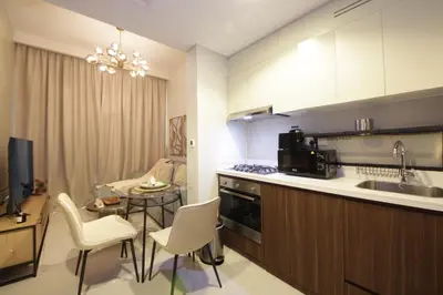 a kitchen with a sink and a table with chairs at New Arabian Reva 1BR Burj Khalifa View in Dubai