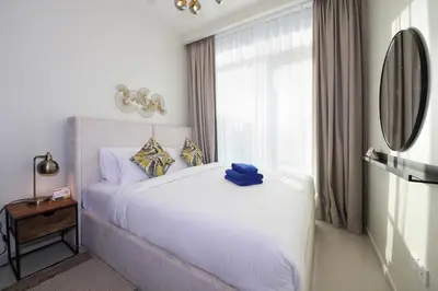 a bedroom with a white bed and a window at New Arabian Reva 1BR Burj Khalifa View in Dubai