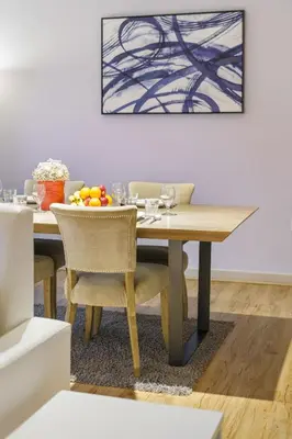 a dining room table with a bowl of fruit on it at Contemporary & Roomy 2BR with Burj Khalifa view in Dubai