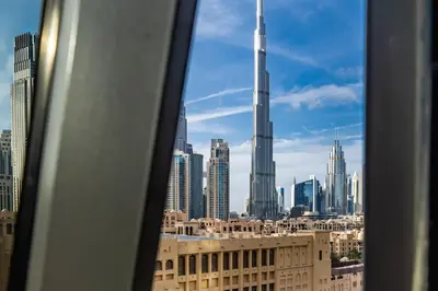 a view of a city skyline from a window at Contemporary & Roomy 2BR with Burj Khalifa view in Dubai