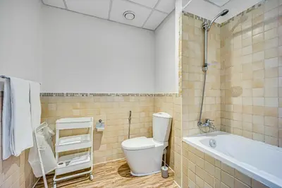 a bathroom with a toilet and a bath tub at New sea view Rimal 2BD in front of the beach in Dubai