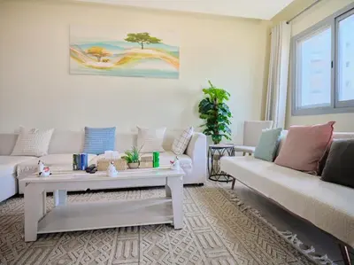 a living room with two couches and a coffee table at Stylish 1 BR with sea view - Sunset view in Dubai