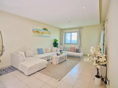 a living room with a couch and a table at Stylish 1 BR with sea view - Sunset view in Dubai