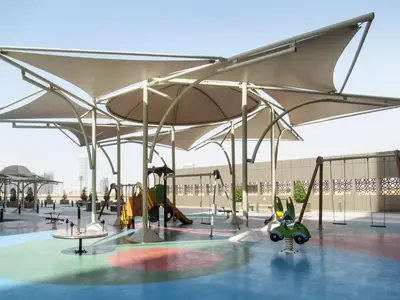 a playground with a large white canopy and swings at Frank Porter - Elite Residence in Dubai