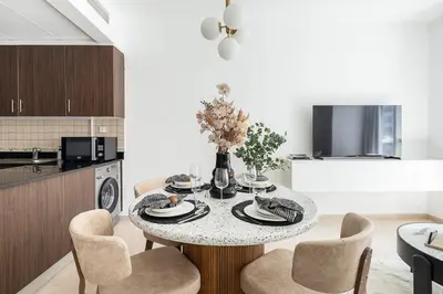a dining room with a table and chairs in a kitchen at Frank Porter - Elite Residence in Dubai