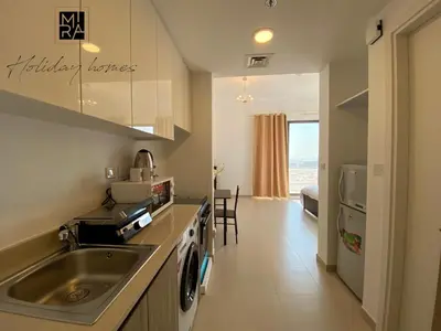 a kitchen with a sink and a counter top at Mira Holiday Homes - Serviced Studio in Una Apartment in Dubai