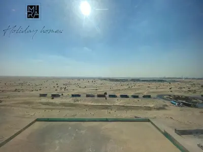 a view of a desert with the sun in the sky at Mira Holiday Homes - Serviced Studio in Una Apartment in Dubai