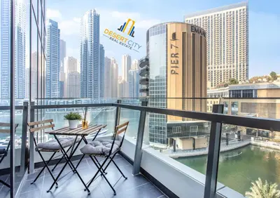 a balcony with a table and chairs and a view of the city at One Bed in Dubai Marina with Marina Views, Hosted by Desert City Stays in Dubai