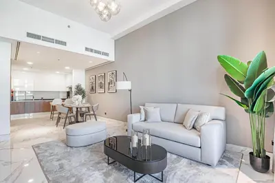a living room with a couch and a table at Daniels Canal View 1BR at J One Business Bay in Dubai