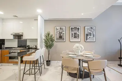 a kitchen and dining room with a table and chairs at Daniels Canal View 1BR at J One Business Bay in Dubai