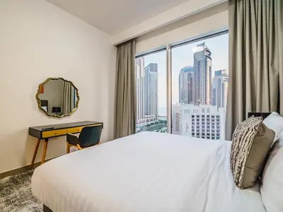 a hotel room with a large bed and a window at Incredible Waterfront Apt with Panoramic Views in Dubai