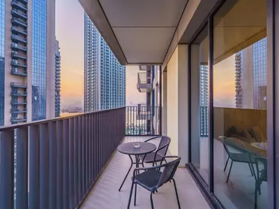 a balcony with chairs and a table on top of a building at Incredible Waterfront Apt with Panoramic Views in Dubai