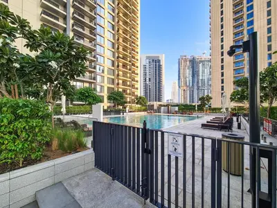 a swimming pool in a city with tall buildings at Incredible Waterfront Apt with Panoramic Views in Dubai