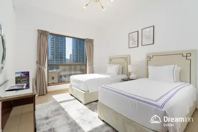 a hotel room with two beds and a window at Dream Inn Apartments - Sadaf Residence JBR in Dubai