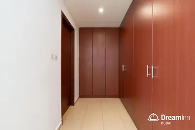 a corridor with wooden cabinets and a hallway with a corridorngthngthngthngthngth at Dream Inn Apartments - Sadaf Residence JBR in Dubai