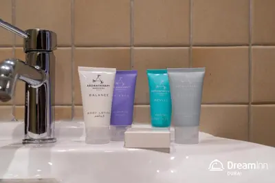 a group of four products sitting on a bathroom sink at Dream Inn Apartments - Sadaf Residence JBR in Dubai