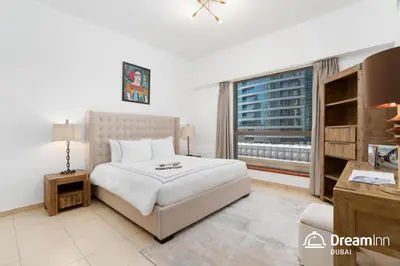 a bedroom with a large bed and a window at Dream Inn Apartments - Sadaf Residence JBR in Dubai