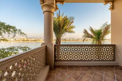 a balcony with a view of the water at Maison Privee - Exclusive Villa with Private Pool, Garden & Beach in Dubai