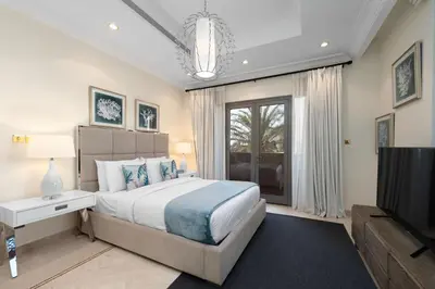 a bedroom with a large bed and a television at Maison Privee - Exclusive Villa with Private Pool, Garden & Beach in Dubai