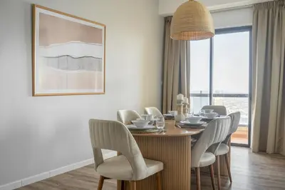 a dining room with a wooden table and chairs at GuestReady - Modern and luxe near JBR Beach in Dubai