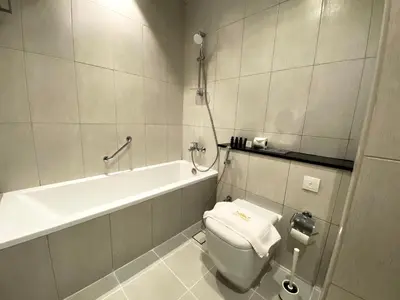a bathroom with a toilet and a bath tub at Lux BnB Studio Ghalia JVC in Dubai