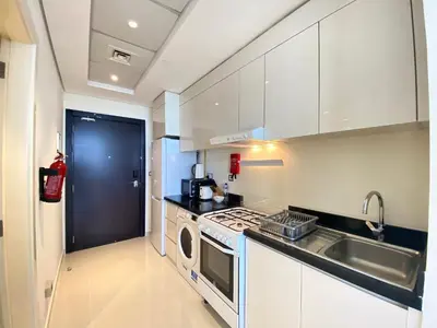 a kitchen with a sink and a stove top oven at Lux BnB Studio Ghalia JVC in Dubai