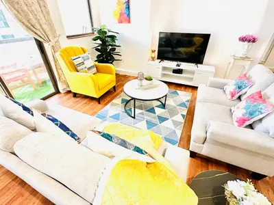 a living room with two couches and a tv at Luxury Casa - Indigo Sea View Apartment JBR Beach 2BR in Dubai