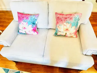a white couch with two pillows on it at Luxury Casa - Indigo Sea View Apartment JBR Beach 2BR in Dubai