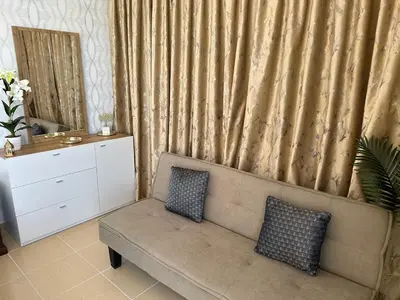 a living room with a couch with two pillows on it at Luxury Casa - Indigo Sea View Apartment JBR Beach 2BR in Dubai