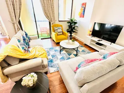 a living room with two couches and a tv at Luxury Casa - Indigo Sea View Apartment JBR Beach 2BR in Dubai