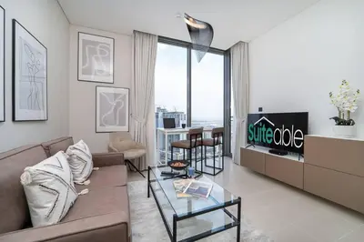 a living room with a couch and a glass table at Intimate Apartment with Scenic View of Dubai Creek in Dubai
