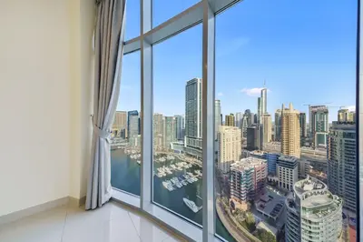 a room with a large window with a view of a city at Impressive View 2BR in Dubai Marina Walk2Beach in Dubai