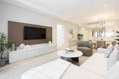 a living room with a couch and a tv at Upgraded Gorgeous 1BR at 5 Star Resort in Dubai