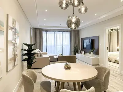 a living room with a table and a couch at Upgraded Gorgeous 1BR at 5 Star Resort in Dubai