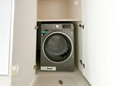 a washer and dryer in a small room at Stylish Studio Apartment in JVC with Contemporary in Dubai