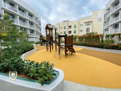 a playground in the middle of a courtyard with buildings at Stylish Studio Apartment in JVC with Contemporary in Dubai