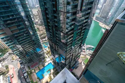an aerial view of a tall building in a city at Vacay Lettings - Suite room in Marina gate, Jumeirah living in Dubai