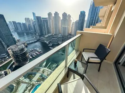 a balcony with a chair and a view of the city at Scenic view studio/Dubai Marina in Dubai