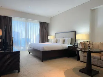 a large hotel room with a bed and a couch at Scenic view studio/Dubai Marina in Dubai