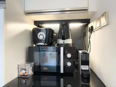 a kitchen with a coffee maker and a microwave at Scenic view studio/Dubai Marina in Dubai