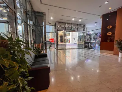 a lobby with a couch in the middle of a building at Cosmos Living Cozy Studio Near Dubai Marina in Dubai