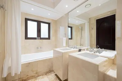 a large bathroom with two sinks and a bath tub at Luxurious Unique 2 Bed with Private Jacuzzi & Garden - Connected to Souk Al Bahar - Dubai Mall in Dubai
