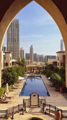 a view of a swimming pool with a city skyline at Luxurious Unique 2 Bed with Private Jacuzzi & Garden - Connected to Souk Al Bahar - Dubai Mall in Dubai
