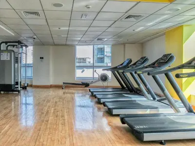 a gym with a row of treadles in a room at GuestReady - Exquisite getaway with Marina views in Dubai