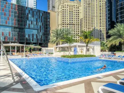 a large swimming pool in a city with tall buildings at GuestReady - Exquisite getaway with Marina views in Dubai