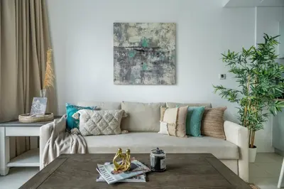 a living room with a couch and a table at GuestReady - Exquisite getaway with Marina views in Dubai